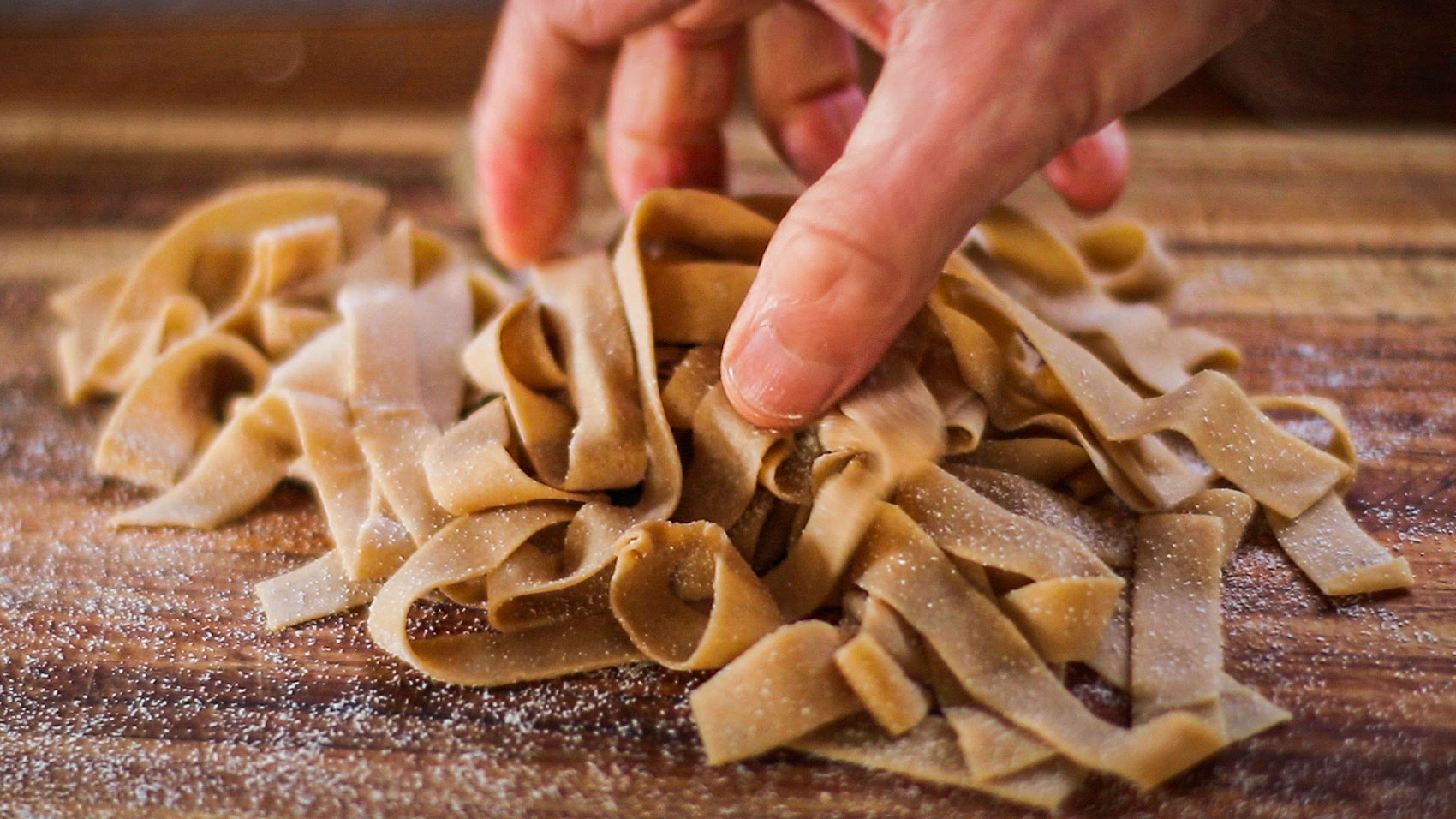 Making pappardelle pasta, cutting pasta dough into strips